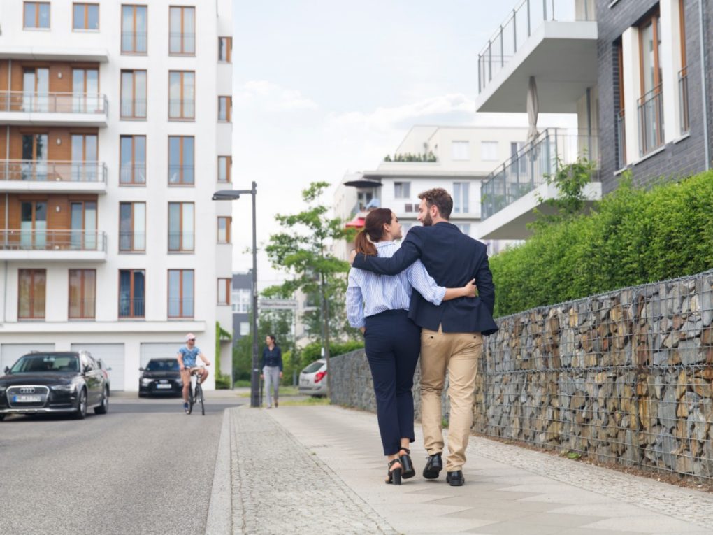 Couple strolling down the street in a newly built housing estate